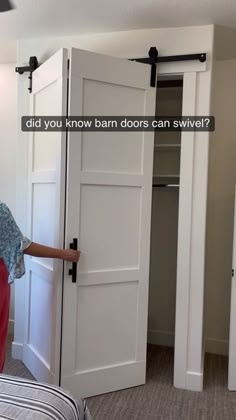 a woman standing in front of an open door with the words did you know barn doors can swive?