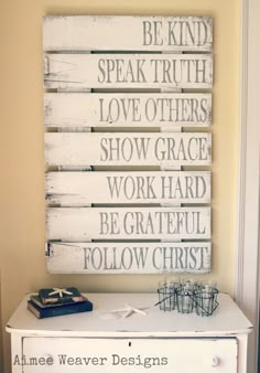 a white dresser topped with a sign that says be kind of speak truth love others show grace work hard be grateful follow christ