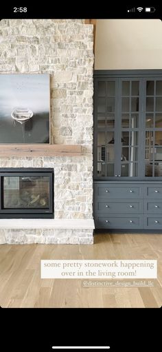 a living room filled with furniture and a fire place next to a stone fireplace mantel