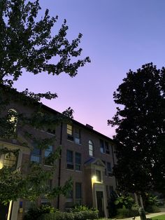 an apartment building is lit up at night