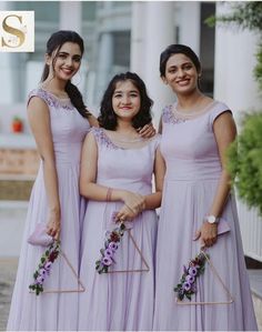 three bridesmaids in lavender dresses posing for the camera