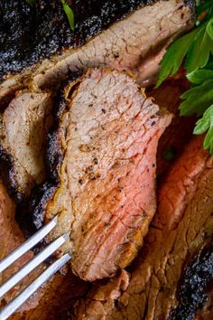 two steaks on a plate with fork and parsley garnish, ready to be eaten