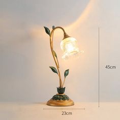 an image of a lamp that is in the shape of a plant with leaves on it