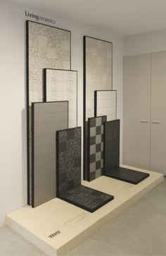 an empty room with several different tiles on the wall and floor, all in black and white