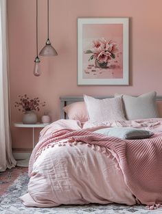 a bedroom with pink walls and bedding in the corner, two lamps hanging from the ceiling