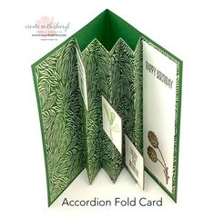 an accordion fold card is open to show the inside of it, and has green leaves on