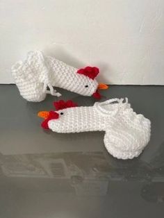 two crocheted chicken shoes are sitting on the floor