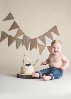 a baby sitting in front of a cake