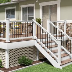 a house with white railings and wooden steps leading up to the front porch area