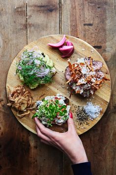 a person holding a plate with different types of food on it