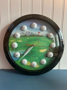 a clock with golf balls painted on it