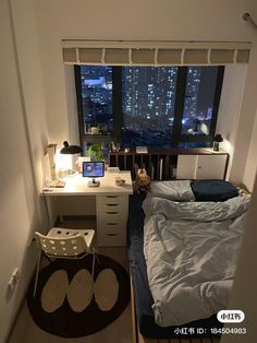 a bed room with a neatly made bed next to a window and a desk in front of it