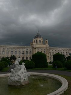 a large building with a fountain in front of it