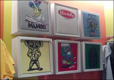 the wall is filled with posters and shirts hanging on it's sides, which are decorated with cartoon characters