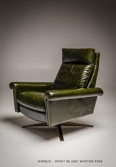 a green leather reclining chair with wooden legs and arm rests against a gray background