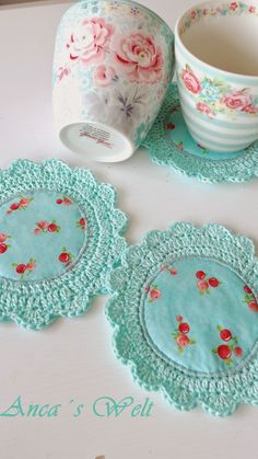 three crocheted coasters and a cup on a table