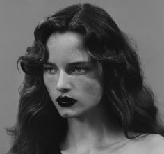 a woman with black lipstick on her lips