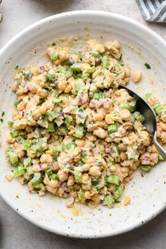 a white bowl filled with chick salad and a spoon