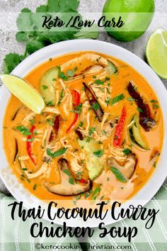 thai coconut curry chicken soup in a white bowl with limes and cilantro