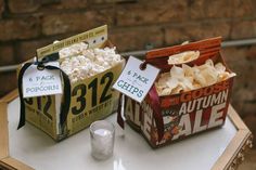 two boxes of popcorn sitting on top of a table