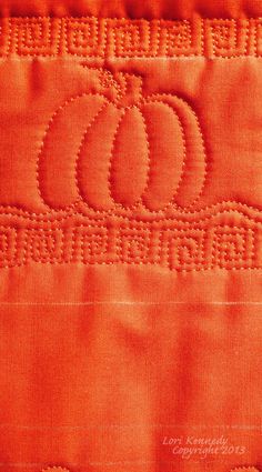 an orange piece of cloth with the letter c on it