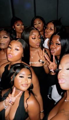 a group of women posing for the camera with their fingers up in front of them