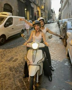 two people on a scooter in the street