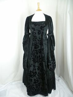 This listing is for a custom made dress,it will be made to the measurements you send me. Please send me your bust,waist and hip measurements,and please measure from the top of your shoulder to the floor with shoes on. It will be made with beautiful jet black crushed velvet and stunning black flocked taffeta....this fabric will also line the inner sleeves.It has a corset style front and back with lacing so you can adjust the dress to fit your body shape. Combined shipping on multiple items. If you purchase express shipping by courier please send me your phone number thank you. Hooded Gown, Black Gothic Dress, Medieval Wedding Dress, Black Wedding Dress Gothic, Dress Medieval, Black Wedding Gowns, Medieval Gown, Medieval Wedding, Custom Made Dress