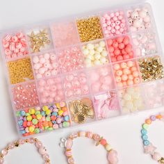 there are many different beads in the plastic box on the table with it's lid open