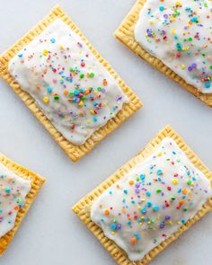 four square crackers with white frosting and sprinkles