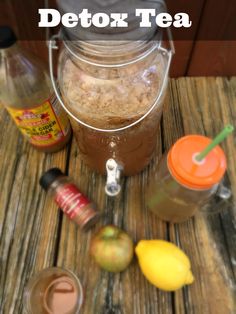 an assortment of food and drinks sitting on a wooden table