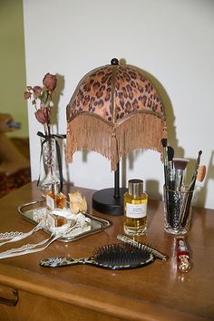 a wooden table topped with an animal print umbrella and other items on top of it