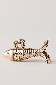 Designed to take any hairdo to the next level, this so cool claw clip is featured in a staple metal fabrication and super unique shape to add a little something special to every style. | Modern Metal Claw Clip by Free People in Gold Fish Claw Clip, Fisherman Aesthetic, Fish Hair Clip, Boat Shoes Outfit, Metal Claw Clip, Free People Hair, Fish Hair, Metal Hair Accessories, 2025 Trends