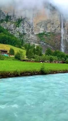 a river running through a lush green valley