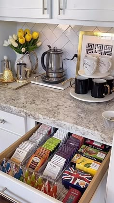 an open drawer in a kitchen filled with teas