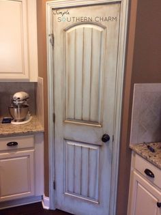 a white door with the name southern charm painted on it in front of a kitchen