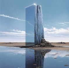 a tall building sitting in the middle of a lake next to a large piece of land