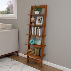 a tall wooden shelf with books on it