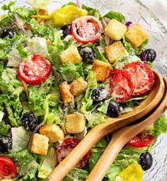 a salad with olives, tomatoes and croutons