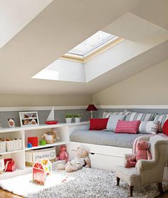 an attic bedroom with white walls and carpeted flooring is decorated in pink and gray