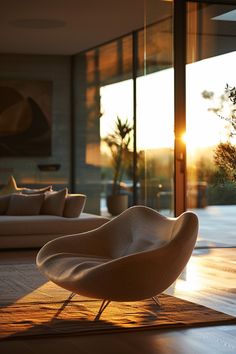 a modern living room with sun shining through the glass doors and floor to ceiling windows