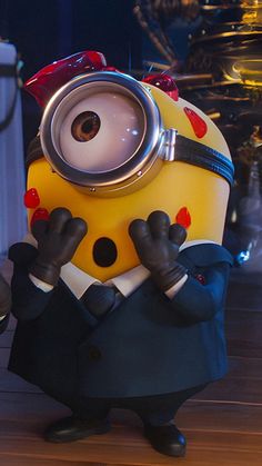 a yellow and black minion dressed in business attire standing on a wooden floor with his hands behind his head