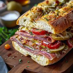 a sandwich with meat and vegetables on a cutting board