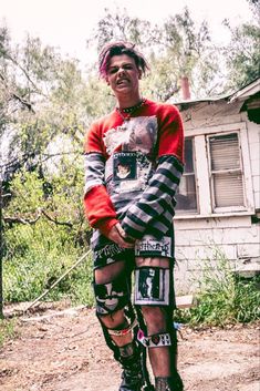 a young man standing on top of a skateboard in front of an old house