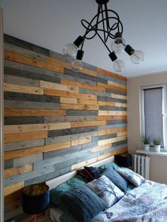 a bedroom with wood paneling on the wall and bed in front of it's headboard