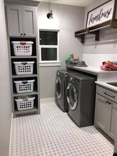 a washer and dryer in a small room with tile flooring on the floor