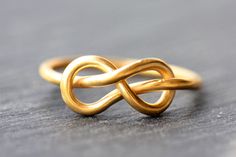 Check our full collection here: https://ajewelryconcept.etsy.com 🌍 FREE DHL Express SHIPPING WORLDWIDE, Delivery in just 2-3 days Hercules Knot A handmade ring, gold wire 1,5 mm K18, plain and simple unique jewelry. Unique design, a ring that combines Ancient Greek style and Contemporary jewellery. It can also be made of Sterling Silver gold plated. MATERIALS: Gold wire 1,5 mm K18 HANDMADE: Every piece is crafted by hand at my workshop, meaning there may be minor deviations from the picture. I Ancient Greek Design, Hercules Knot, Gold Wire Ring, Greek Design, Infinity Love, Mens Engagement, Wire Ring, Family Jewellery, Ring Mens