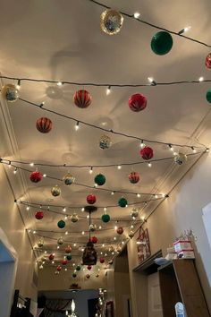 the ceiling is decorated with christmas lights and ornaments