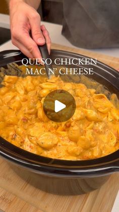 a person cooking macaroni and cheese in a crock pot