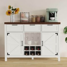 a white cabinet with two wine glasses on top and some flowers in vases next to it